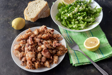Fried calamari on a wooden table