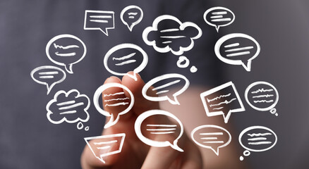 Hand interacting with floating speech bubbles,concept of communication, ideas, and conversation.