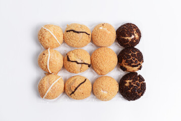 A dozen of mini cream puffs, light airy pastries made from choux dough and filled with sweet cream or custard. They have a crispy, golden brown shell, drizzled with white and dark chocolate icing.