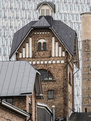 Historic industrial building showcases architectural details in Gothenburg, Sweden with contrasting modern backdrop