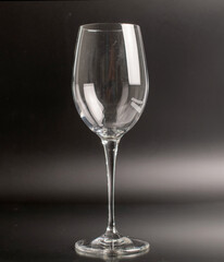 One glass wine glass on a dark gray background, close-up.
