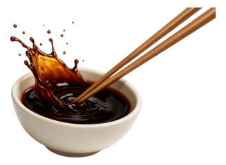 Wooden chopsticks cause a splash in a bowl filled with dark soy sauce, creating dynamic liquid motion on transparent background.