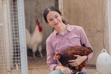 women young people with chicken  learning about farming, farming, and cultivation in a greenhouse.