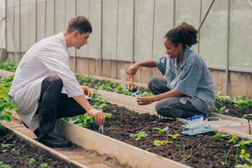 Teachers and students test and research soil for agriculture, farming, and cultivation in...