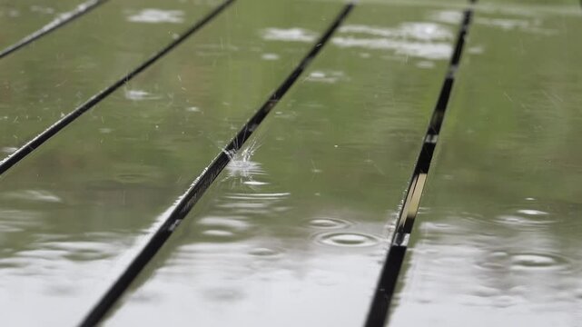 Mando, Denmark Torrential rain flls on a picnic table. 