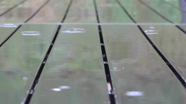 Mando, Denmark Torrential rain flls on a picnic table. 
