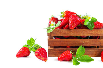 Ripe juicy strawberries with flowers and leaves in a wooden box.