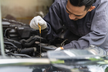 car service shop concept. Automobile repairman work checking change engine oil
