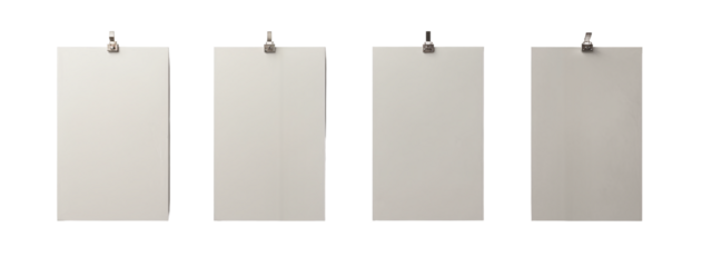 A set of four blank white posters hanging on a white wall.