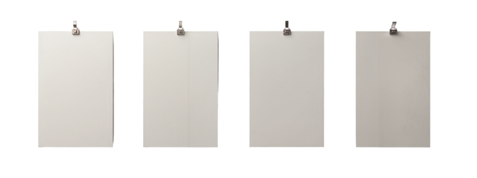 A set of four blank white posters hanging on a white wall.