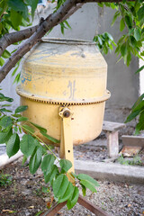 concrete is loaded into a cart from a 200 liter orange electric concrete mixer, photo taken on a...