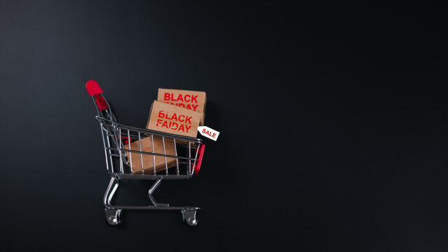 E-commerce promotions, and discount shopping. Miniature shopping cart with BLACK FRIDAY tag, symbolizing major sales events, Ideal for retail advertising, holiday deals, Consumer purchasing concepts.