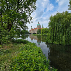 Naklejka premium A Beautiful Serene Castle Reflection in Lush Greenery Surrounded by Natures Beauty Maschpark Hannover
