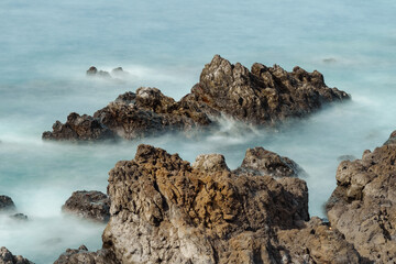 Waves crashing on rocks at the beach