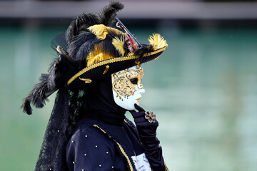 Woman wearing traditional mask and costume.   Annual venetian carnival of Annecy, Haute Savoie,...
