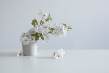 spring flowers in ceramic vase on white table