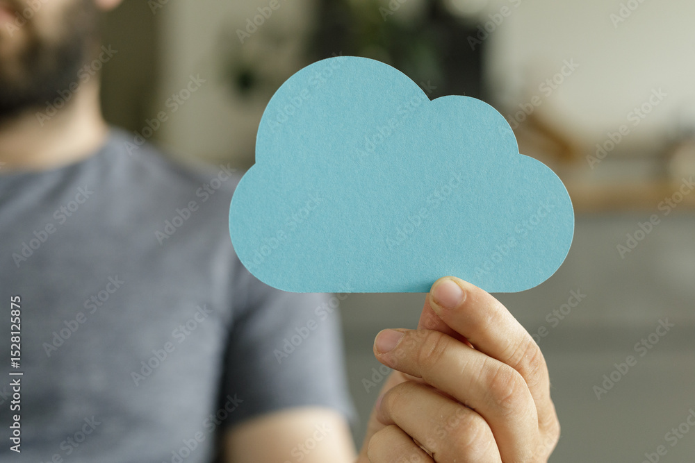 Poster Image of a person holding a paper cloud, representing cloud computing, data storage, and digital technology.