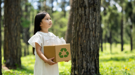 Child Holding Recyclables Box in Forest