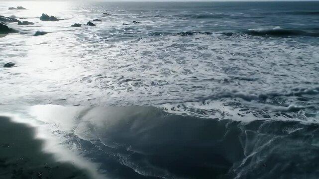 A wide Top down view aerial drone video of powerful ocean waves crashing onto a dark, rugged shoreline.