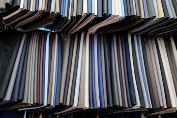 Naklejka premium Tailor shop. Custom made suit with a large selection of fabrics. Custom tailoring workshop for men with a large selection of fabrics. Ho Chi Minh city. Vietnam.