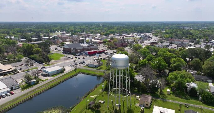 Historical American small town architecture. Water tower in Starke, old town in Florida state. Streets and buildings from above.