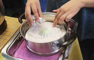 Vendor Placing Bootoo from Mold and Placing in Steamer, a Thai Muslim Dessert Made of Ground Rice with Palm Sugar Fillings