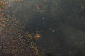 High-resolution photo of dark metal surface with rust and scratches. Ideal for backgrounds and textures.