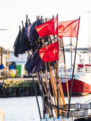 Fishing boat adorned with flags in a vibrant Swedish harbor during a sunny day