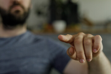 Close-up image of a man's hand pointing.  Perfect for concepts of direction, choice, or guidance.