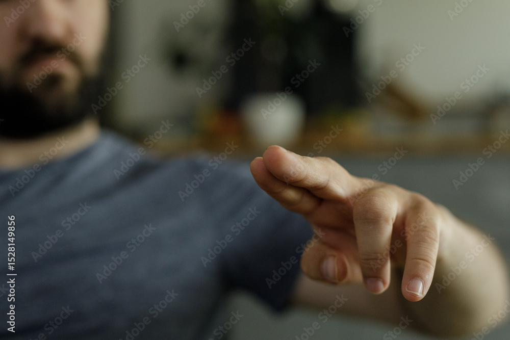 Poster close-up image of a man's hand pointing, perfect for concepts related to direction, guidance, or cho