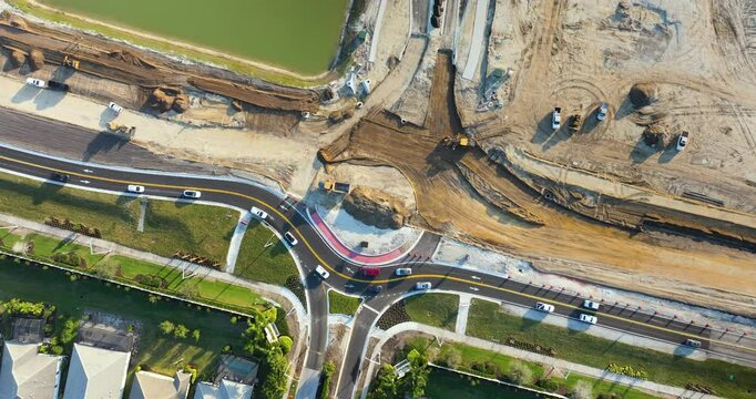 Roundabout intersection construction in North Port, Florida. Development of American road circle with moving traffic cars. Urban circular transportation crossroads.