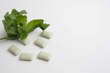 Peppermint chewing gum and mint on the table. Fresh breath, oral care. Hygiene and health
