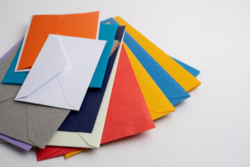 Paper envelopes on a light background. New mail, write a message. Send and receive mail. Postal delivery service. Empty envelope, empty space. Communication with people, paperwork. Envelope close-up