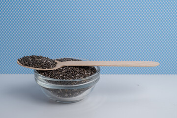 Chia seeds in a wooden spoon on the table. Superfood. Antioxidants for health
