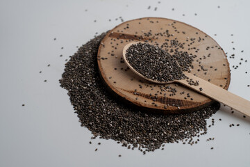 Chia seeds in a wooden spoon on the table. Superfood. Antioxidants for health