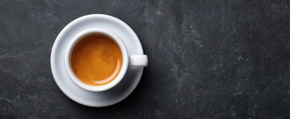 The elegant espresso cup filled with rich coffee on a textured surface.