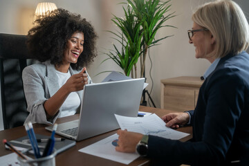 Woman consulting with a female financial manager at the bank.