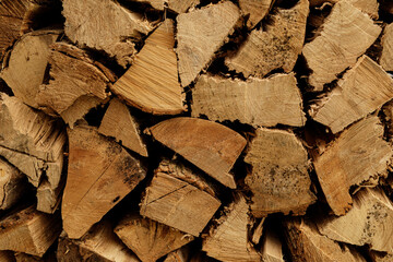 High-resolution image of neatly stacked firewood, showcasing the rich brown tones and natural...