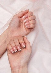 Woman showing french manicure on pink background
