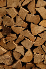 Close-up of neatly stacked firewood, ideal for winter warmth and cozy ambiance.  Perfect for blogs,...