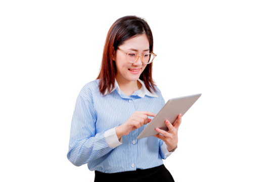 Asian young beautiful woman in glasses and a striped shirt is using a tablet with a focused and pleasant expression.
