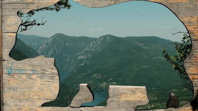 Wooden bear-shaped photo frame overlooking Drina River and lush green mountains at Banjska Stena viewpoint in Tara National Park. Serbia country. Zooming effect