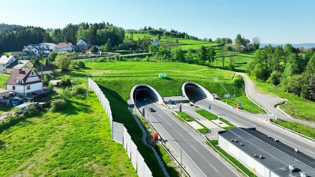 New tunnel on Zakopianka highway in Poland. The tunnel is 2 over km long and makes travel from Krakow to Zakopane, Podhale region and Slovakia much faster. Old road above. Aerial 4K video