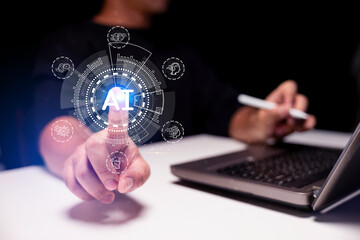A person interacts with a futuristic AI interface, highlighting artificial intelligence technology next to a laptop and digital pen.