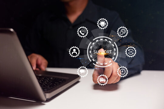 A person uses a laptop while interacting with a digital support interface displaying various service icons in a futuristic design.