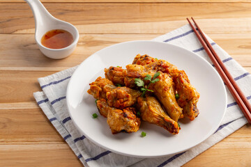 Air Fryer drummet chicken wing with salt on white plate (Gai Tod Glue),Healthy cooking less oil and crispy.