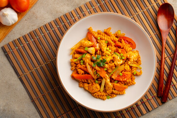 Stir Fried Spiral Macaroni with chicken meat tomatoes and egg in Tomato Sauce.fusion food