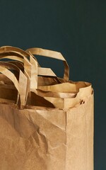 Paper bags on a black background. Empty bags. Minimalist design, paper bag pieces, golden effect. Sustainable packaging, Groceries delivery concept