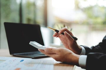 Accountant working with computer tablet in modern office, preparing accounting analysis report,...