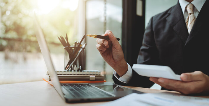 Accountant working with computer tablet in modern office, preparing accounting analysis report, real estate investment information, financial and tax system concept.